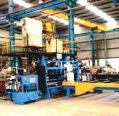 Fabrication machinery inside a covered workshop.
