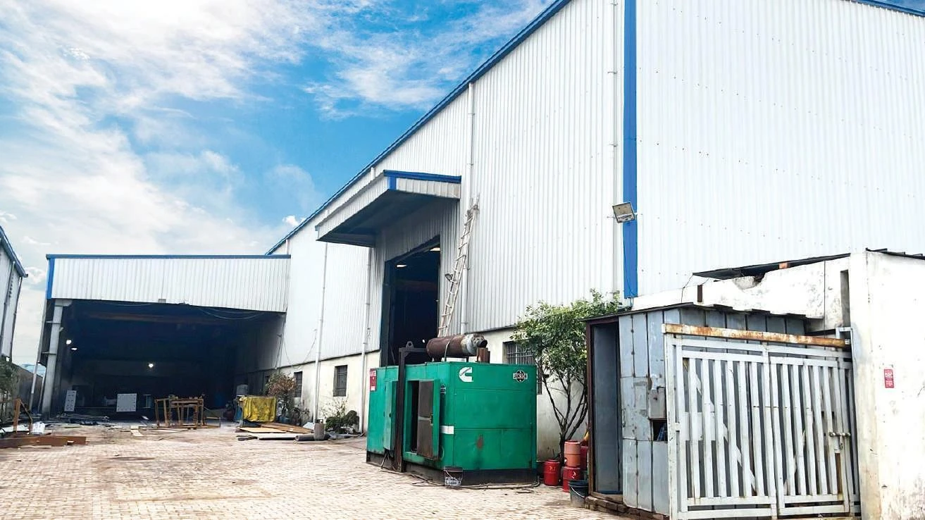 Exterior of an industrial workshop with large entry bays.